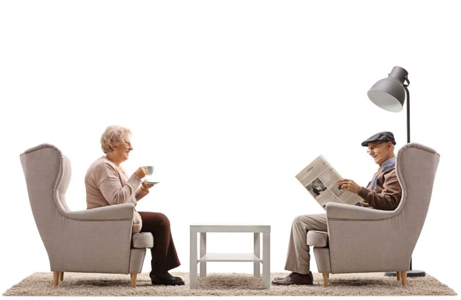 Two old men sitting on chairs and talking.